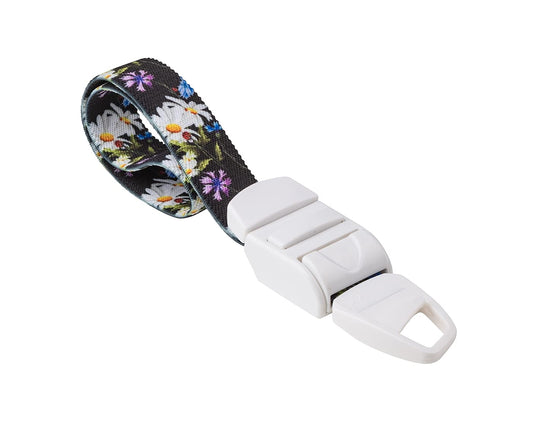 MEDICININIS TURNIKETAS su laukų gėlių raštų dirželiu ir balta sagtele.